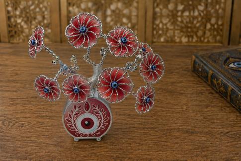 OJO TURCO | ARBOL OJO TURCO CON FLORES COLOR ROJO Y BASE OJO TURCO ACABADO MATE 20 X 17 CM.