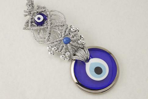 AMULETOS Y TALISMANES | CHARM MACRAMAME PLATEADO CON OJO TURCO DE CRISTAL 7 X 20 CM.