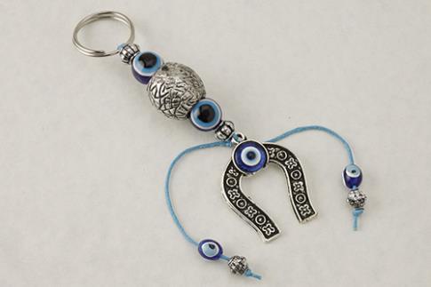 AMULETOS Y TALISMANES | LLAVERO METAL HERRADURA Y OJO CRISTAL 5 X 17 CM.
