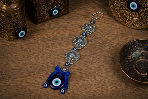OJO TURCO | OJO TURCO PARA COLGAR CON 3 GANESHAS TONOS AZULADOS Y CUENTAS COLOR PLATEADO 25 X 6 CM.